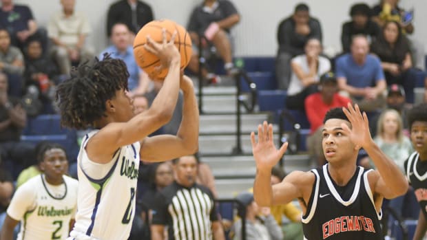 Windermere's Ta'Veon Jones goes for a 3-pointer against Edgewater's Erik Taylor during the first half Wednesday. Jones scored a game-high 26 points in the Wolverines' 83-75 victory. Taylor had 14 points.
